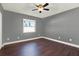 Well-lit bedroom featuring wood-look floors, a ceiling fan, and a bright window at 912 Lochmont Dr, Brandon, FL 33511