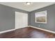 Bedroom featuring gray walls, white trim, and a window, providing a calm and neutral atmosphere at 912 Lochmont Dr, Brandon, FL 33511