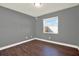 Bedroom with gray walls, white trim, and a window providing a clean and bright space at 912 Lochmont Dr, Brandon, FL 33511