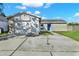 Charming single-story home featuring a large driveway and an attached garage at 912 Lochmont Dr, Brandon, FL 33511