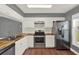 Well-lit kitchen with stainless steel appliances, wood countertops, and classic white cabinets at 912 Lochmont Dr, Brandon, FL 33511