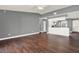 Open-concept living space with wood-look floors and an eat-in kitchen with white cabinetry at 912 Lochmont Dr, Brandon, FL 33511