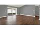 Spacious living room with wood-look floors and sliding glass doors to a screened patio at 912 Lochmont Dr, Brandon, FL 33511