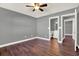 Serene main bedroom with hardwood flooring, a ceiling fan, and en-suite bathroom at 912 Lochmont Dr, Brandon, FL 33511