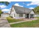 Exterior view of home with detached garage, manicured lawn, and visible air conditioning units at 1016 Mandalay Dr, Brandon, FL 33511