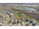 Aerial view of a Primary-planned community, showcasing the neighborhood's layout, lakes, and residential areas at 10944 Delta Huff Ct, San Antonio, FL 33576