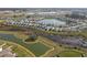 Aerial view of a residential area featuring beautiful ponds and well-maintained homes in a desirable location at 10944 Delta Huff Ct, San Antonio, FL 33576