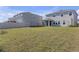 Large backyard featuring an expansive grassy area, perfect for outdoor activities and relaxation at 10944 Delta Huff Ct, San Antonio, FL 33576