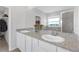 Granite countertop and dual sinks in bathroom next to closet and a glass door shower at 10944 Delta Huff Ct, San Antonio, FL 33576