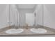 Bathroom featuring a double sink vanity with granite countertops and a large mirror at 10944 Delta Huff Ct, San Antonio, FL 33576