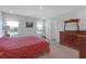 Spacious bedroom with water view windows, walk-in closet, and a decorative wooden dresser at 10944 Delta Huff Ct, San Antonio, FL 33576