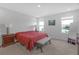 Bright bedroom featuring two windows with a view, a queen bed and side tables at 10944 Delta Huff Ct, San Antonio, FL 33576