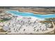 Aerial view of community lagoon featuring white sand beach and lounge area with clear blue water at 10944 Delta Huff Ct, San Antonio, FL 33576