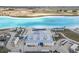 Aerial view of community pool featuring recreational area, equipment and azure water at 10944 Delta Huff Ct, San Antonio, FL 33576