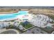 Aerial view of community lagoon featuring recreation, parking, and blue green water at 10944 Delta Huff Ct, San Antonio, FL 33576
