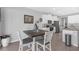 Comfortable dining area with white chairs, wood table, and access to the kitchen at 10944 Delta Huff Ct, San Antonio, FL 33576