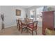 Bright dining room featuring a wooden table with six chairs and large windows at 10944 Delta Huff Ct, San Antonio, FL 33576