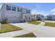 Two-story home with a well-manicured lawn and a long driveway leading to the attached garage at 10944 Delta Huff Ct, San Antonio, FL 33576