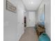 Inviting hallway with neutral walls, tiled floors, and decorative accents at 10944 Delta Huff Ct, San Antonio, FL 33576