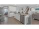 Well-appointed kitchen with granite countertops, stainless steel appliances, and white cabinetry, leading to dining area at 10944 Delta Huff Ct, San Antonio, FL 33576
