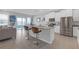 Open-concept kitchen with white cabinets, granite countertops, stainless steel appliances, and a breakfast bar at 10944 Delta Huff Ct, San Antonio, FL 33576