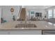 Kitchen island featuring granite countertops, stainless steel appliances, and view into the living room at 10944 Delta Huff Ct, San Antonio, FL 33576