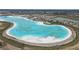 Expansive lagoon featuring a sandy beach, providing a resort-style experience for community residents at 10944 Delta Huff Ct, San Antonio, FL 33576