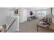 Spacious, carpeted upstairs living area with large windows for plenty of natural light at 10944 Delta Huff Ct, San Antonio, FL 33576