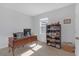 Home office space is well-lit with a built-in bookshelf and desk at 10944 Delta Huff Ct, San Antonio, FL 33576