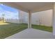 Covered patio area perfect for outdoor relaxation and entertaining, with a view of the spacious backyard at 10944 Delta Huff Ct, San Antonio, FL 33576