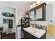 Bathroom with vanity, unique stone tile accent, and a view of the walk-in closet at 114 S Gunlock Ave, Tampa, FL 33609