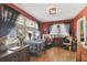 Cozy dining room featuring hardwood floors, natural light, and vintage decor at 114 S Gunlock Ave, Tampa, FL 33609