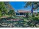 Inviting backyard with an American flag, enclosed porch, and beautifully landscaped garden beds, perfect for outdoor living at 11427 Turtle Dove Pl, New Port Richey, FL 34654