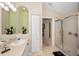 Bathroom showcasing a single sink vanity with decorative niche and glass enclosed shower at 11427 Turtle Dove Pl, New Port Richey, FL 34654