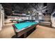 Billiards room with multiple pool tables under modern lighting, offering a relaxing and social atmosphere at 11427 Turtle Dove Pl, New Port Richey, FL 34654