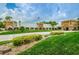 Community clubhouse with manicured lawns and colorful landscaping, offering residents a welcoming space for recreation and events at 11427 Turtle Dove Pl, New Port Richey, FL 34654
