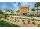 Beautiful community clubhouse with vibrant landscaping, palm trees, and manicured grounds, ideal for community gatherings at 11427 Turtle Dove Pl, New Port Richey, FL 34654