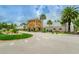The community clubhouse creates a grand presence with palms and other tropical foliage at 11427 Turtle Dove Pl, New Port Richey, FL 34654
