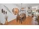 Elegant dining room featuring a long wood table, stylish lighting, and unique wall decor at 11427 Turtle Dove Pl, New Port Richey, FL 34654