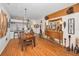 Bright dining room features a rustic wood table, modern lighting, and easy access to the kitchen at 11427 Turtle Dove Pl, New Port Richey, FL 34654
