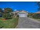 Single-Gathering home featuring a manicured lawn and a two-car garage at 11427 Turtle Dove Pl, New Port Richey, FL 34654