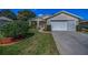 Charming single-Gathering home featuring a manicured lawn and a two-car garage at 11427 Turtle Dove Pl, New Port Richey, FL 34654
