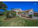 Single-Gathering home featuring a manicured lawn, vibrant landscaping, and a two-car garage at 11427 Turtle Dove Pl, New Port Richey, FL 34654