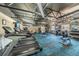 An open fitness center featuring treadmills, stationary bikes, weights, and other exercise machines on a carpeted floor at 11427 Turtle Dove Pl, New Port Richey, FL 34654