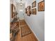 Stylish hallway features wood flooring, decorative rugs, and wall art, leading to the main living areas at 11427 Turtle Dove Pl, New Port Richey, FL 34654