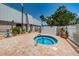 Cozy hot tub area with brick paved patio and lush plantings at 11427 Turtle Dove Pl, New Port Richey, FL 34654