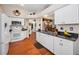 Spacious kitchen featuring white cabinetry and black countertop at 11427 Turtle Dove Pl, New Port Richey, FL 34654