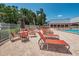 Resort-style poolside patio area with comfortable seating and lush landscaping at 11427 Turtle Dove Pl, New Port Richey, FL 34654