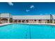 Inviting community pool with plenty of seating and manicured grounds at 11427 Turtle Dove Pl, New Port Richey, FL 34654