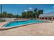 Expansive community pool featuring plenty of deck space and lounge seating at 11427 Turtle Dove Pl, New Port Richey, FL 34654